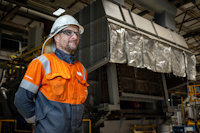 Hydro employee in front of furnace at Høyanger Recycling